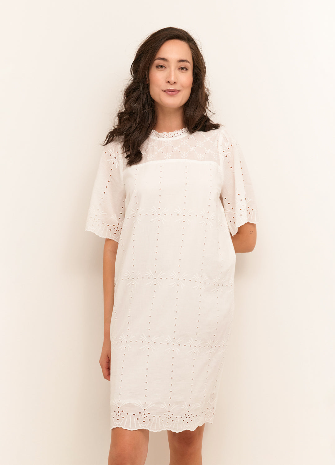 Front view of the Cream Clothing Denmark Moccamia Dress in Snow White cotton with eyelet detailing at Inner Beach Co, Toronto, Ontario, Canada