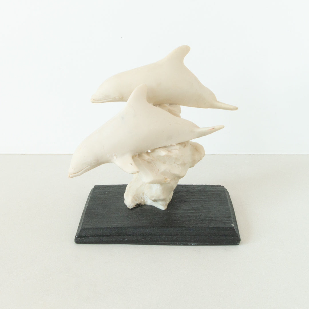Vintage sculpted pair of dolphins mounted on dark wood base at Inner Beach Co, Toronto, Canada
