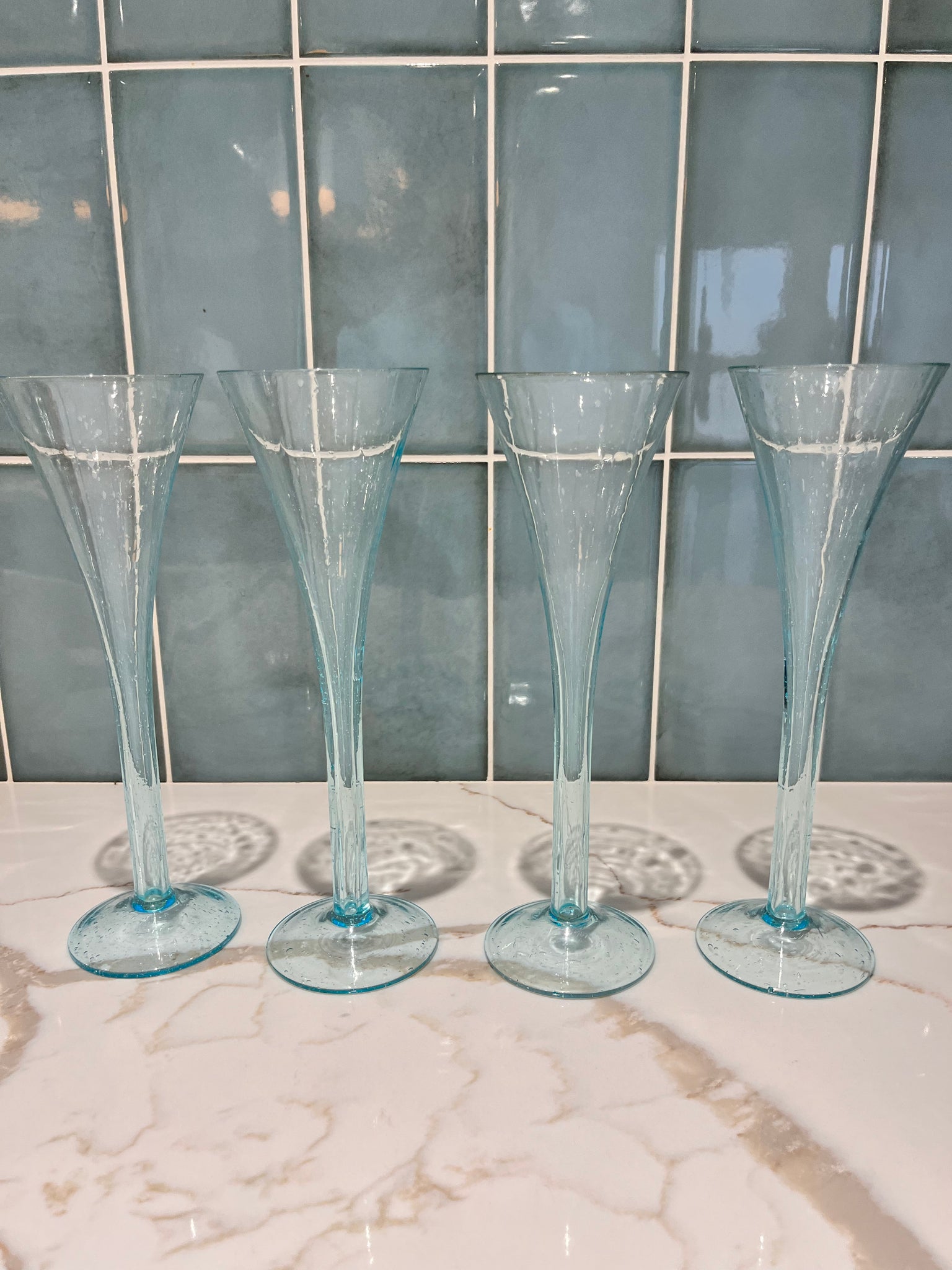 4 Champagne Flutes with hollow stems.