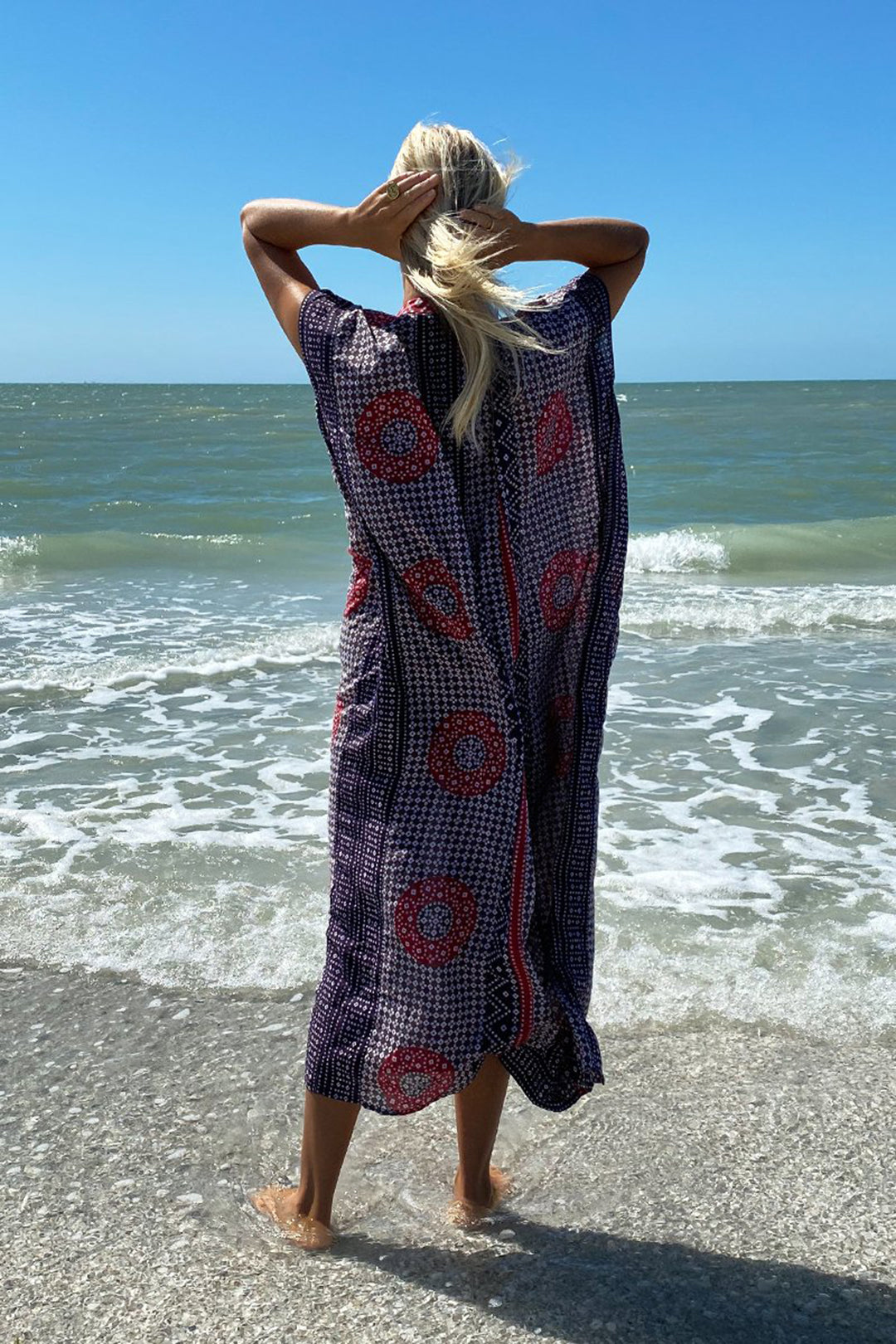 At the beach in the Emerson Fry Emerson Caftan beach cover-up in Butterfly Organic red and purple print at Inner Beach Co, Toronto, Canada