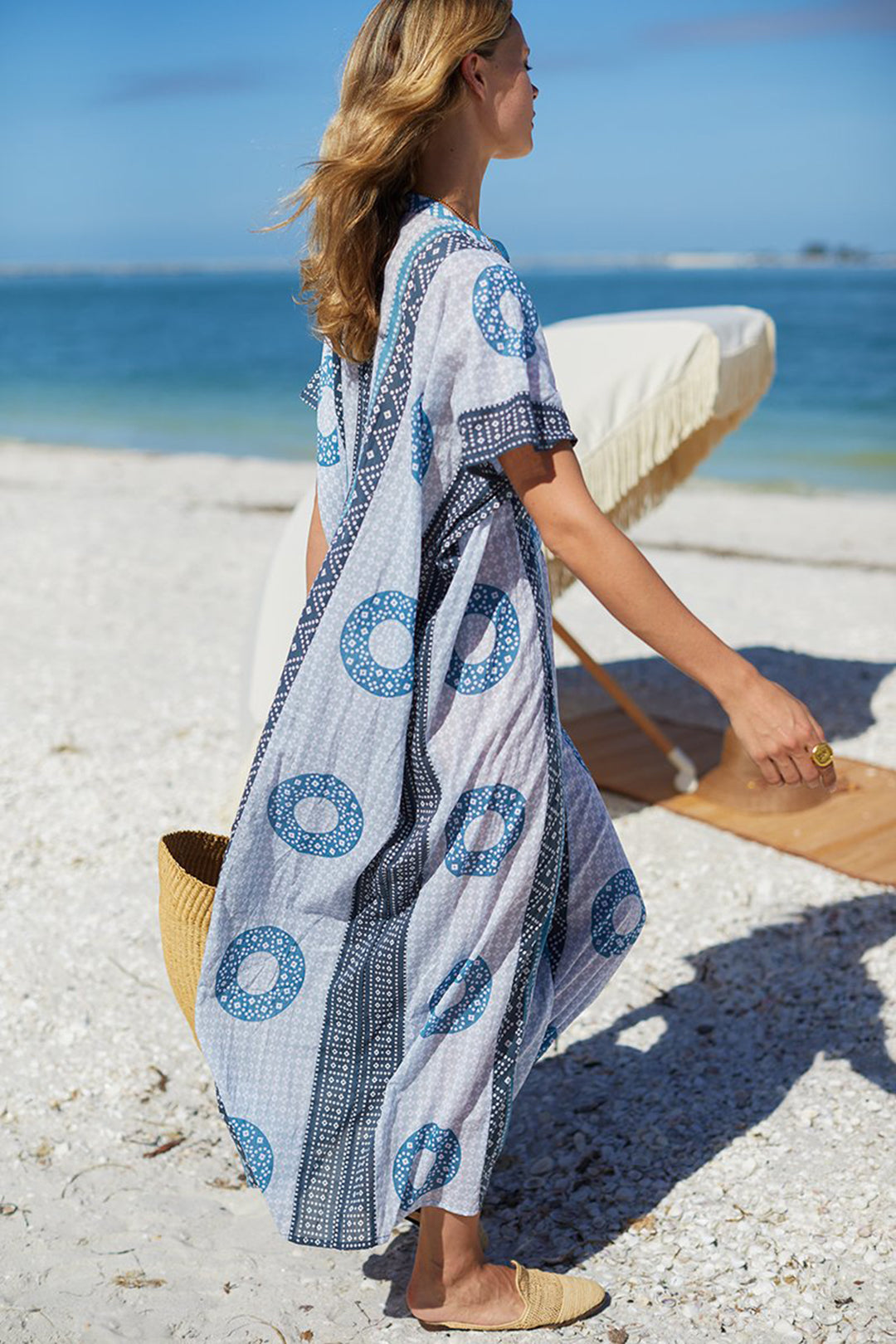 At the beach in the Emerson Fry Emerson Caftan beach cover-up in Cerulean Organic blue print at Inner Beach Co, Toronto, Canada