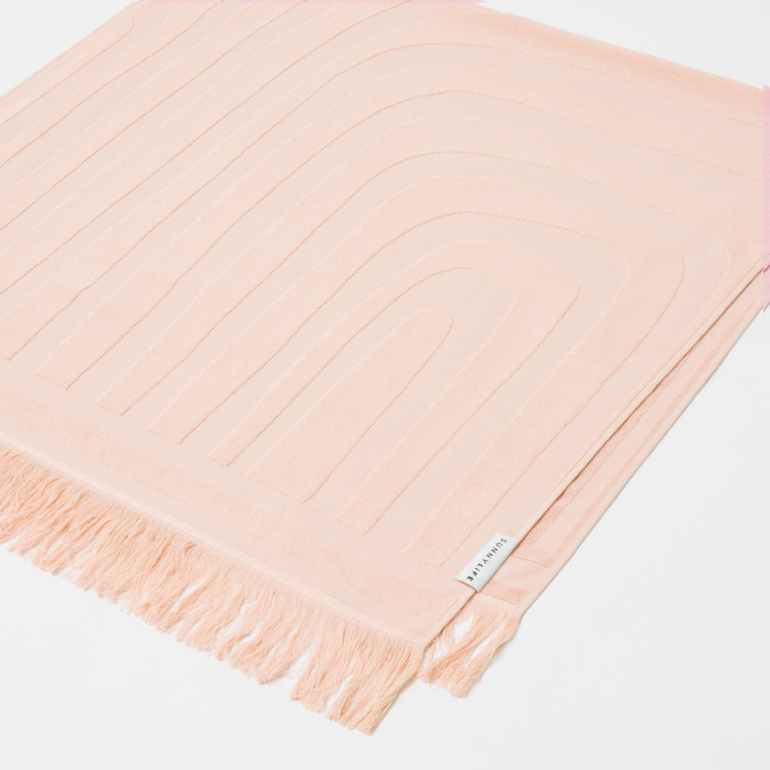 SUNNYLiFE Luxe Beach Towel in salmon pink colour made from premium 420gsm Jacquard cotton terry towelling at Inner Beach Co, Toronto, Canada