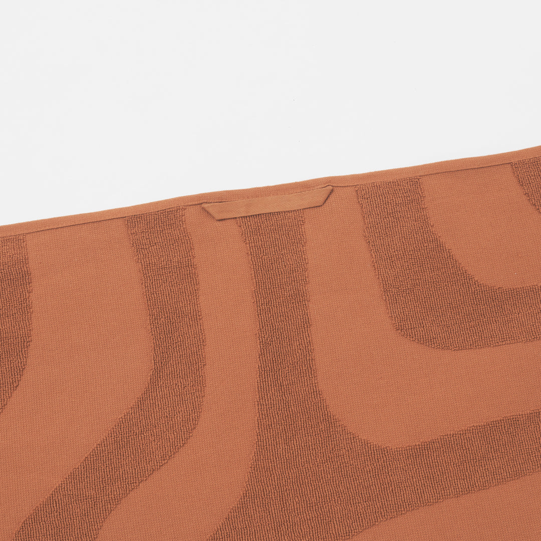 Hanging loop detail on the SUNNYLiFE Luxe Beach Towel in terracotta orange colour made from premium 420gsm Jacquard cotton terry towelling at Inner Beach Co, Toronto, Canada