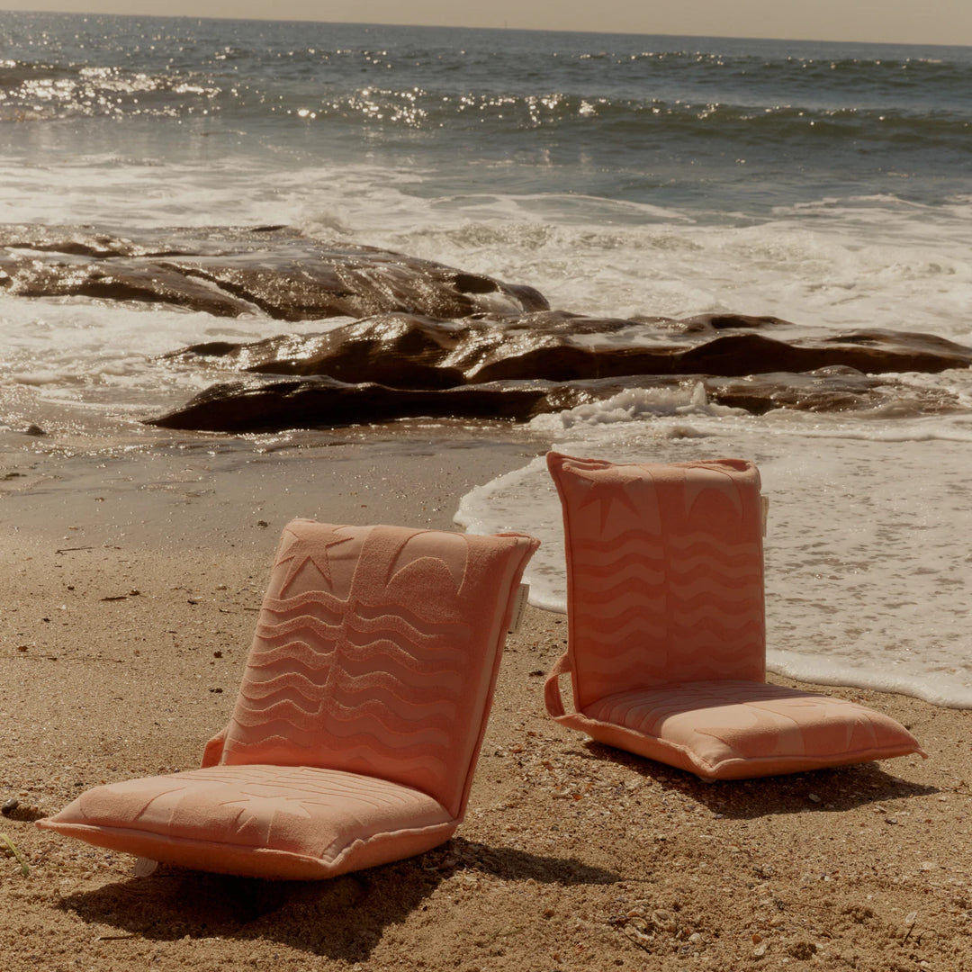 Limited edition SUNNYLiFE X Daimon Downey Terry Travel Lounger Chair in salmon pink with 6 adjustable reclining settings at Inner Beach Co, Toronto, Ontario, Canada