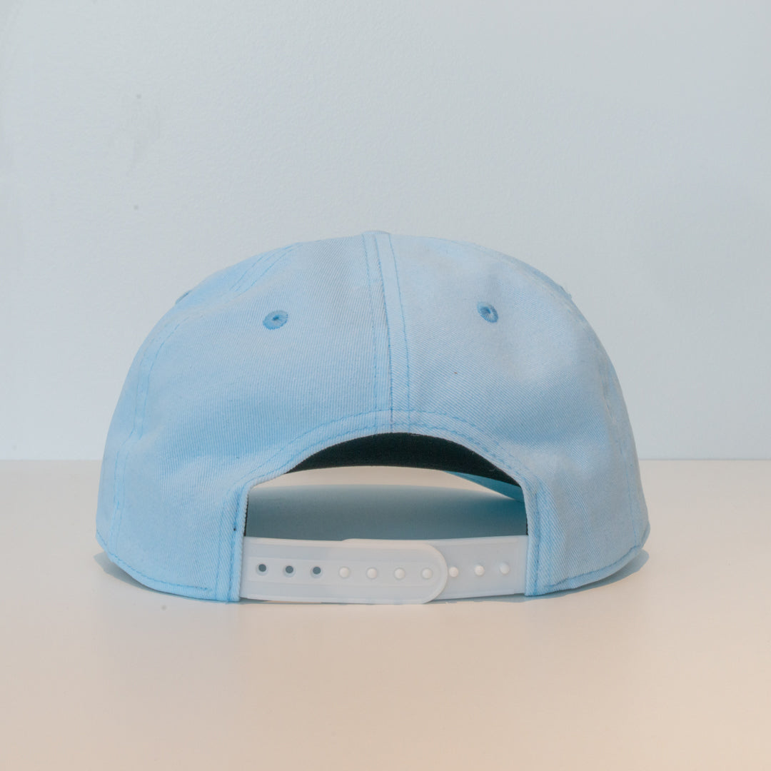 Frost Blue comfy unstructured 5-panel hat with beautifully embroidered custom Inner Beach design on canvas patch.