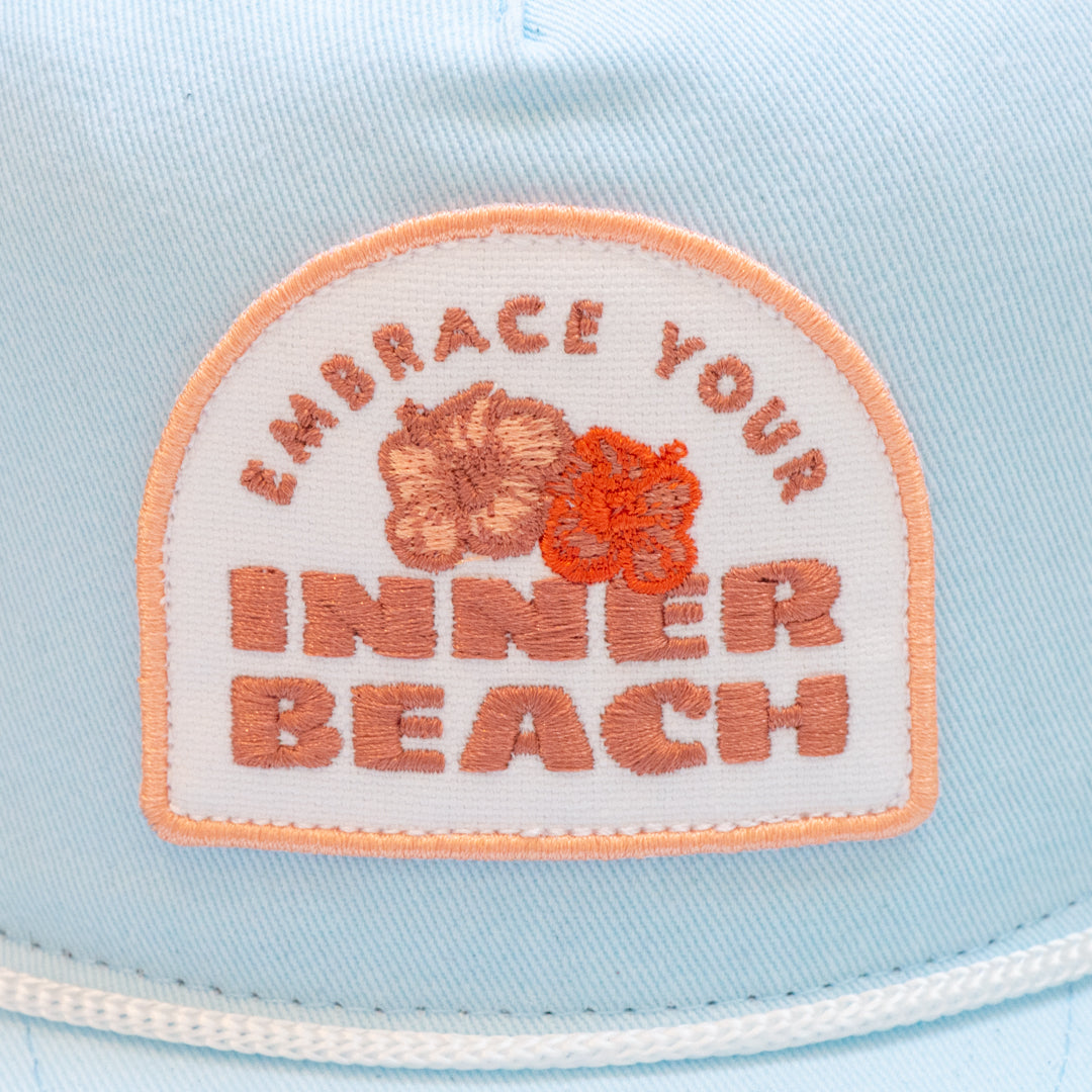 Frost Blue comfy unstructured 5-panel hat with beautifully embroidered custom Inner Beach design on canvas patch.