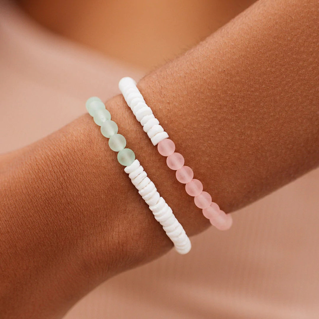 Pura Vida Puka Shell & Frosted Bead Stretch Bracelet in Pink and Mint feature natural puka shell beads and bright frosted beads at Inner Beach Co, Toronto, Ontario, Canada