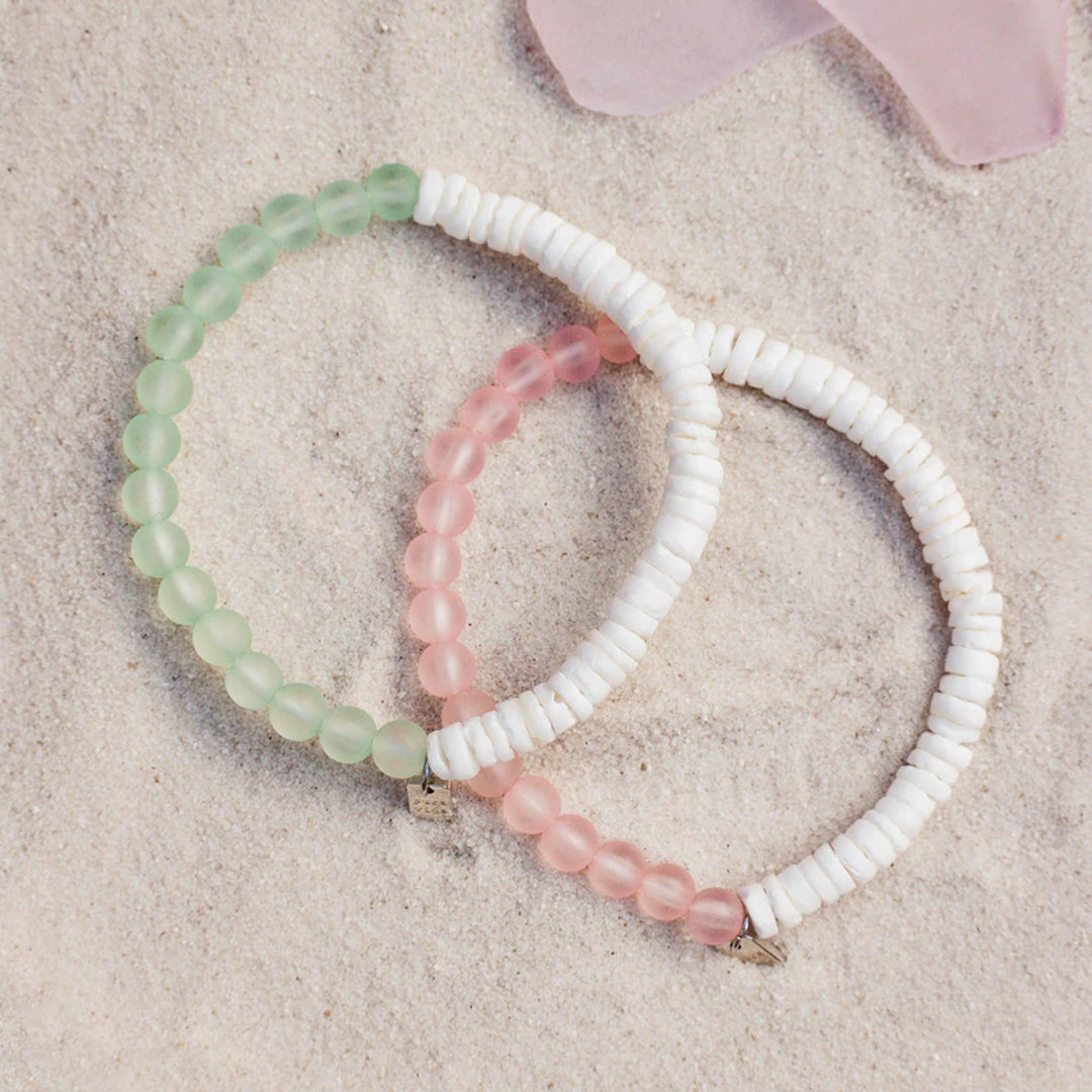 Pura Vida Puka Shell & Frosted Bead Stretch Bracelet in Pink and Mint feature natural puka shell beads and bright frosted beads at Inner Beach Co, Toronto, Ontario, Canada