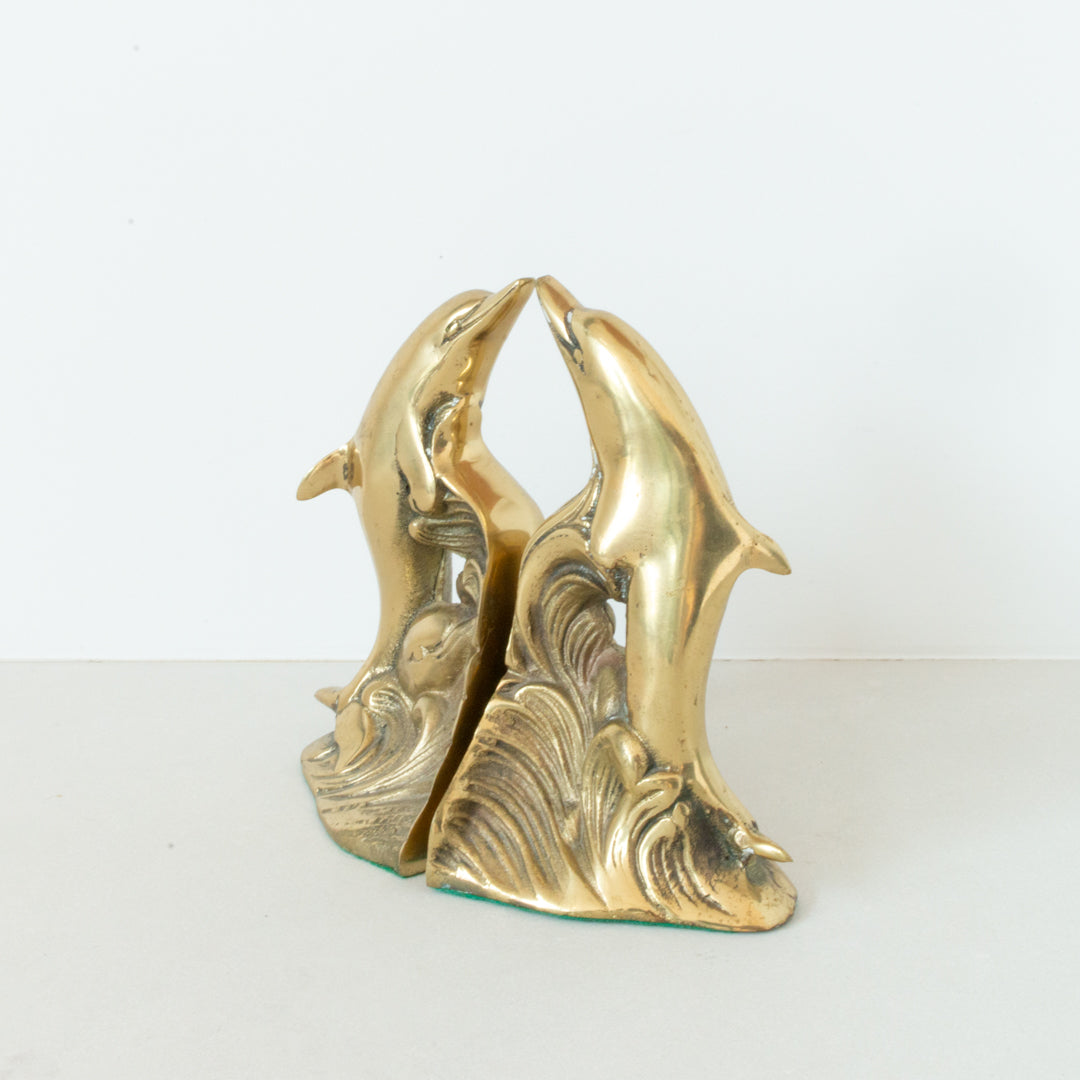 Pair of vintage solid polished dolphin bookends with felt base at Inner Beach Co, Toronto, Canada