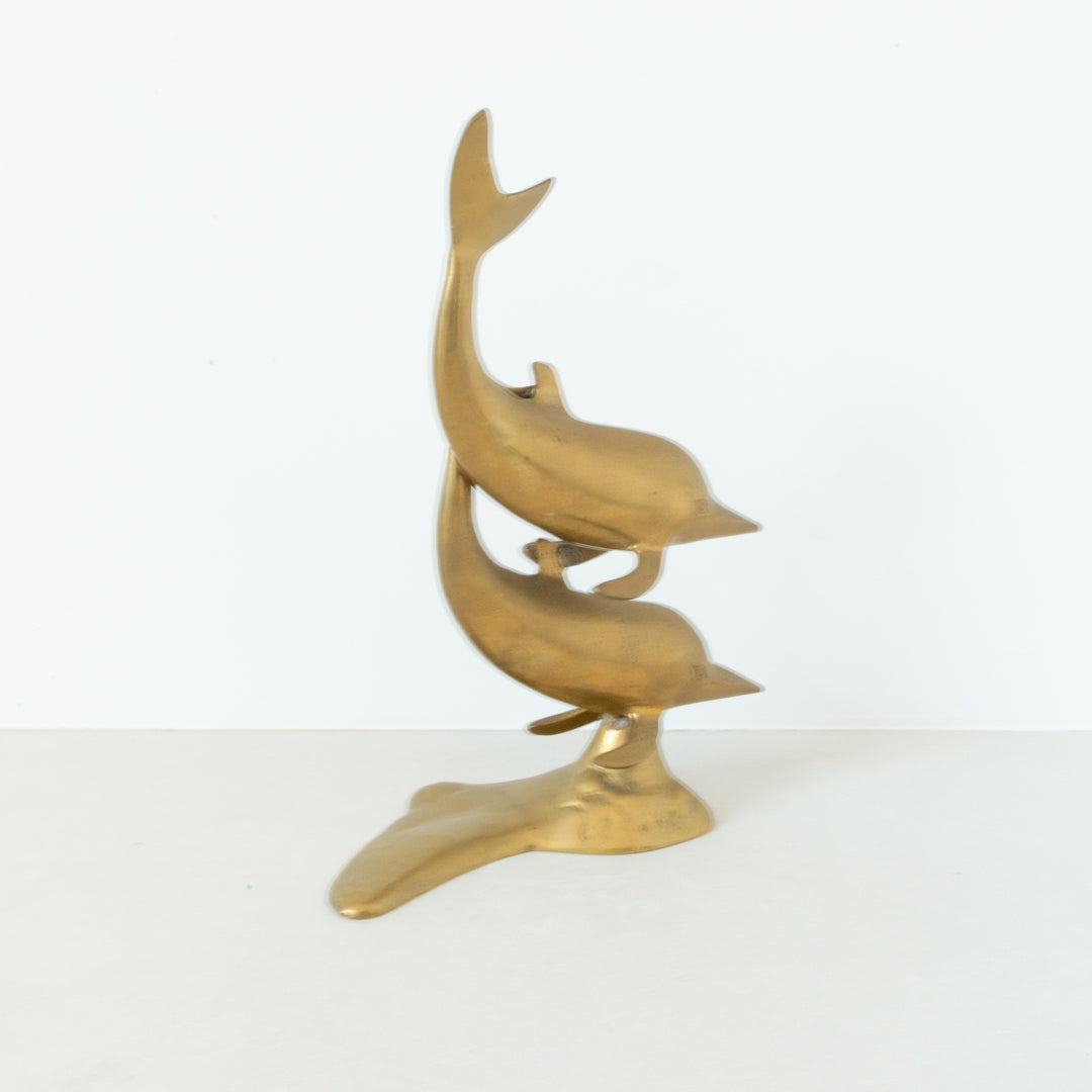 Vintage brass figurine depicting a pair of dolphins playing in the surf at Inner Beach Co, Toronto, Canada