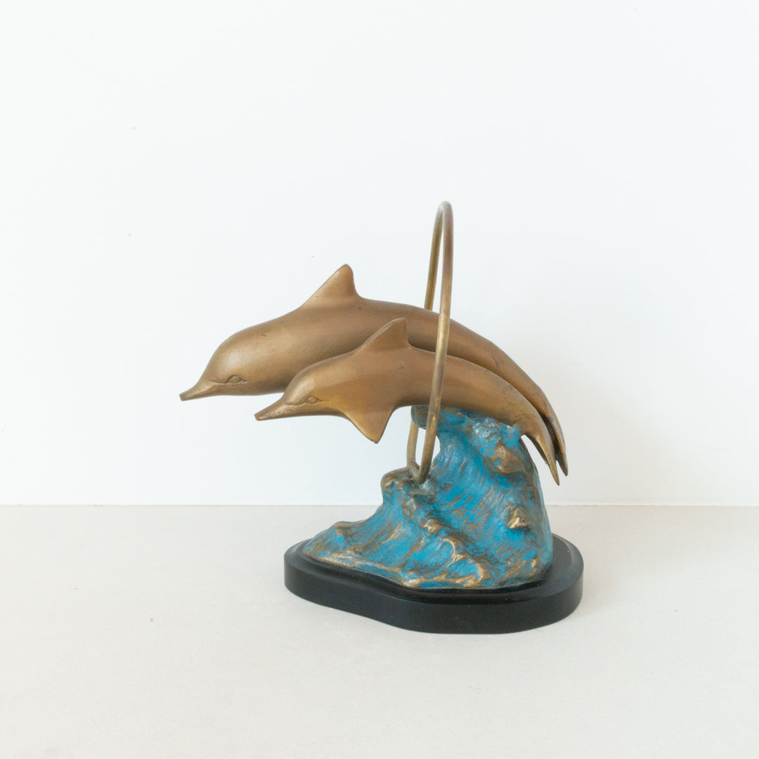 Vintage brass figurine depicting a pair of dolphins jumping through a hoop available at Inner Beach Co, Toronto, Canada