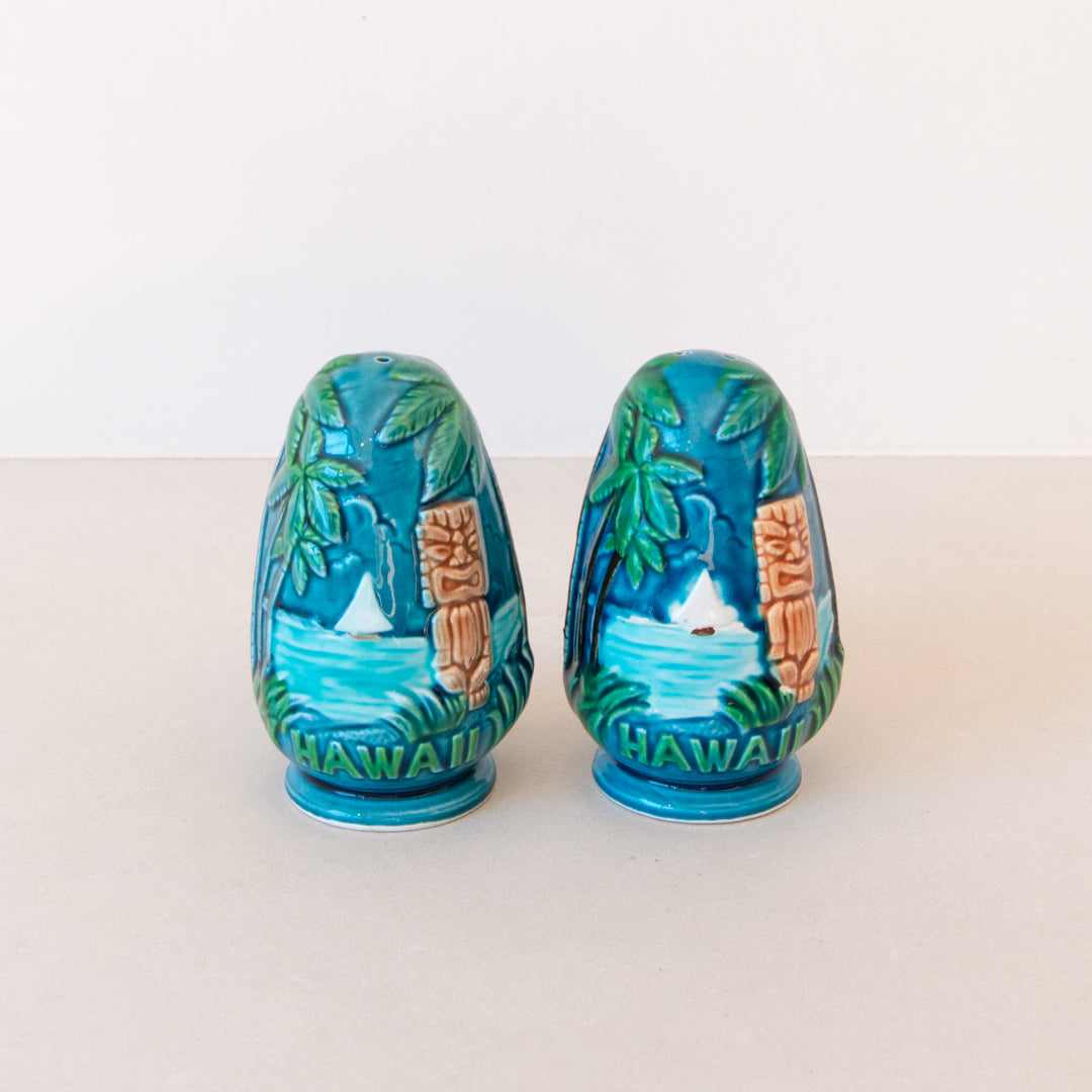 Vintage set of majolica-style Hawaii souvenir salt and pepper shakers with hibiscus flowers, tiki, palm trees and a boat at Inner Beach Co, Toronto, Canada