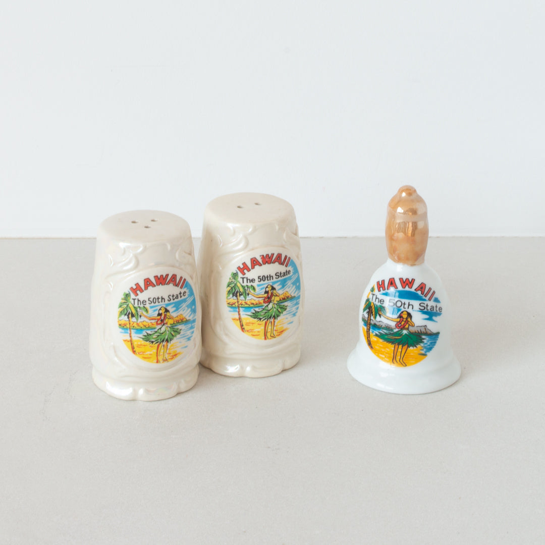 Vintage ceramic 'Hawaii The 50th State' salt and pepper shaker set and souvenir bell at Inner Beach Co, Toronto, Canada