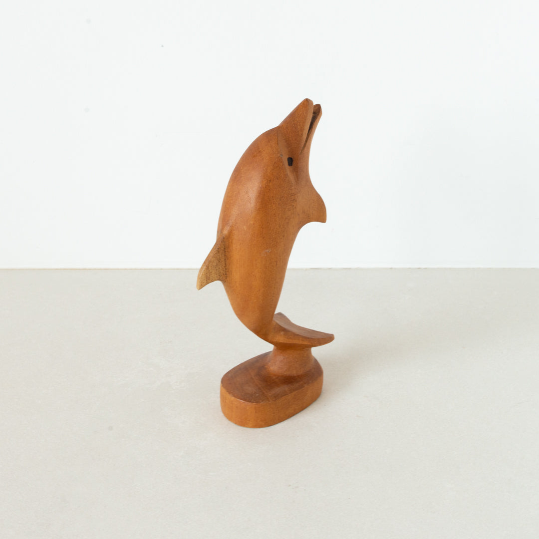 Vintage carved light wood dolphin on base at Inner Beach Co, Toronto, Canada