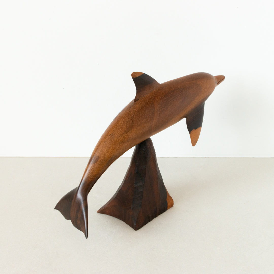 Vintage carved wood dolphin, balanced on wood pedestal at Inner Beach Co, Toronto, Canada
