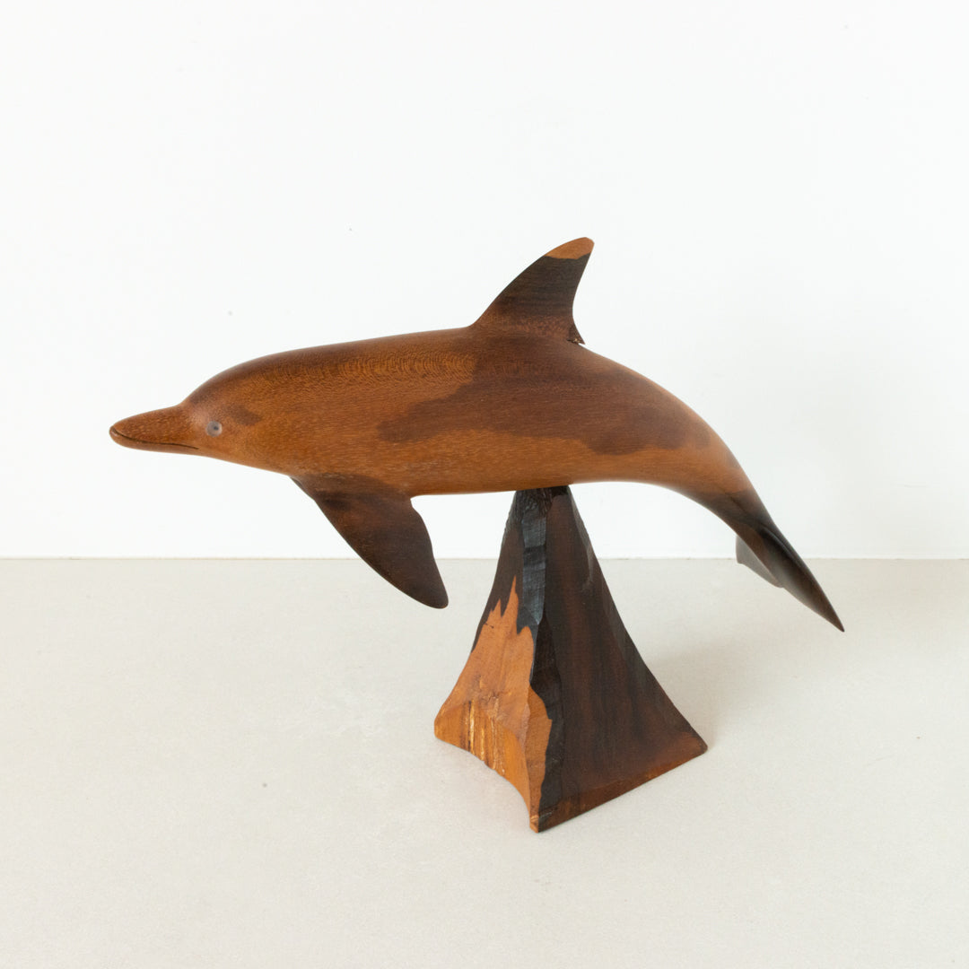 Vintage carved wood dolphin, balanced on wood pedestal at Inner Beach Co, Toronto, Canada